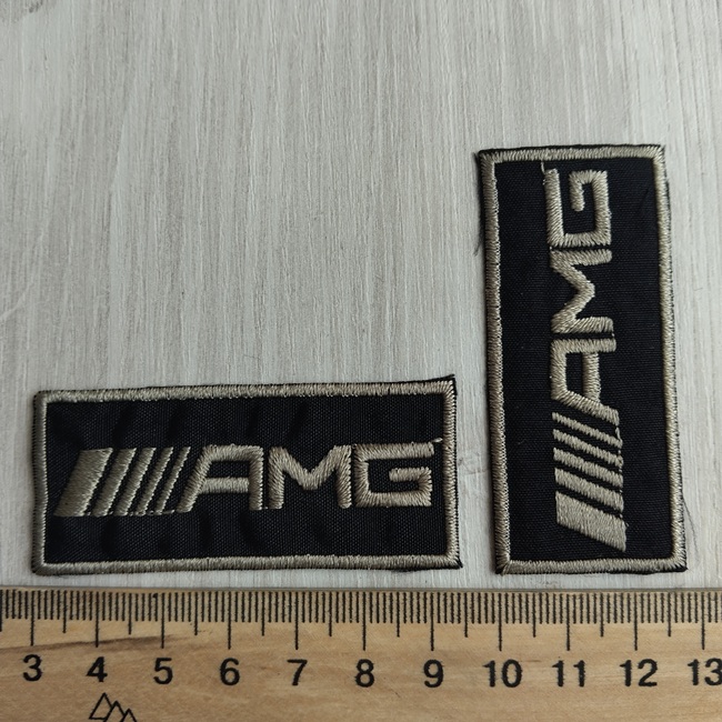 Нашивка клейова, чорна з оливковим написом 65х28 мм