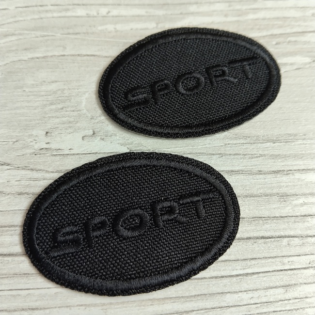Нашивка клейова, Спорт чорна, овальна 50х32 мм